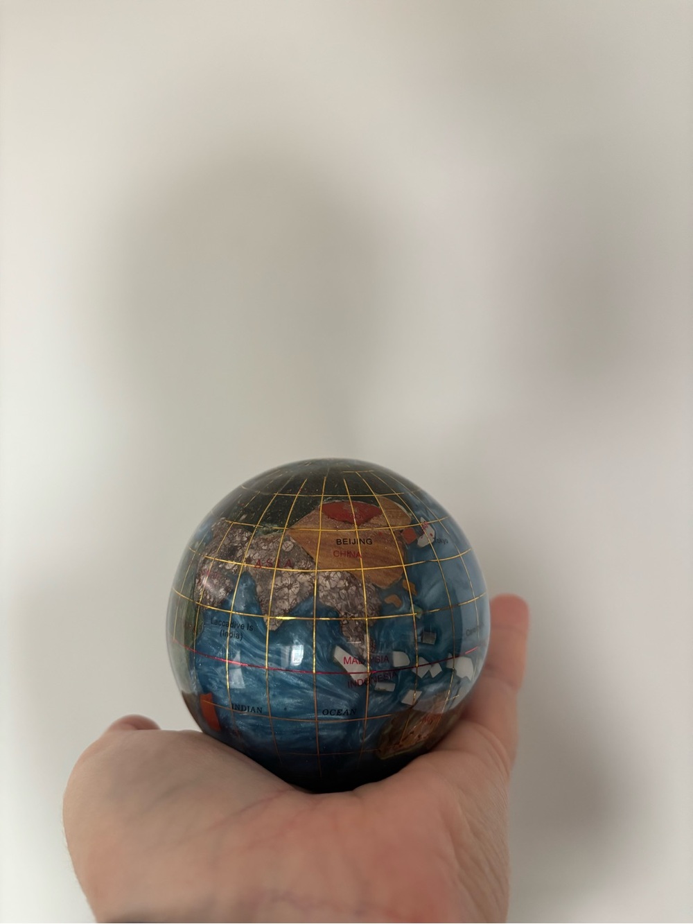 Alexander Kalifano gemstone globe paperweight featuring a blue ocean finish